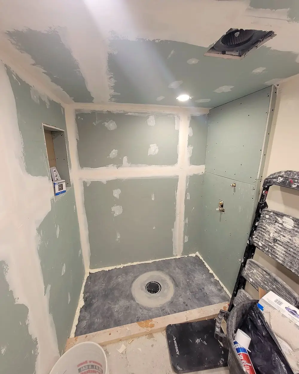 A shower niche framed into the wall of a basement bathroom before waterproofing